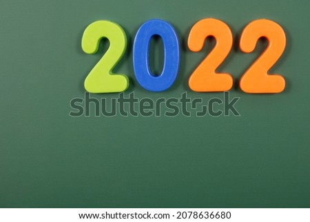 2022 year written in bright plastic magnetic letters stuck on a magnetic board