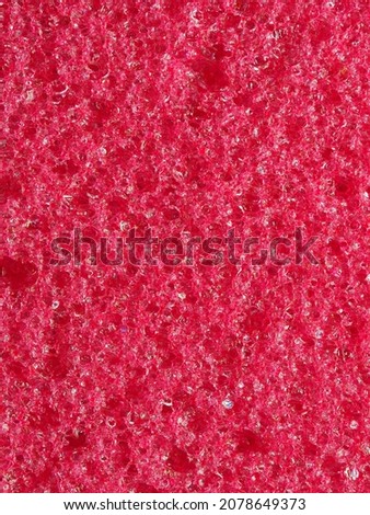 close-up, background, texture, large vertical banner. heterogeneous surface fine pore structure bright saturated red pumice stone for finger care. full depth of field. high resolution photo