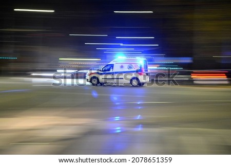 An evening intersection in the city with blurry moving vehicles. Royalty-Free Stock Photo #2078651359