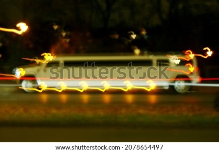 A stretch limousine at night in motion in Berlin-City.      
