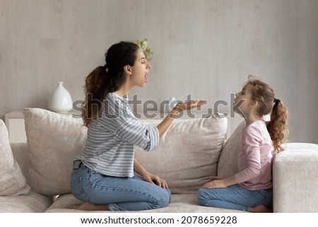 Caring mother with little daughter kid speaking studying at home together, stuttering or disabled cute girl child doing speech exercises with professional therapist teacher, practicing pronunciation Royalty-Free Stock Photo #2078659228