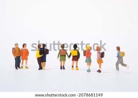 miniature group of school children with school bag on white background