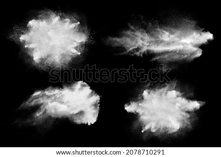 Set of dust powder splash clouds isolated on black. Flour particles exploding over dark background