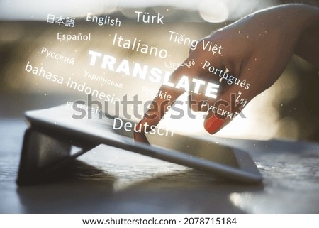 Close up of hand using tablet with abstract text on blurry background. Translation, foreign language, service and education concept. Double exposure