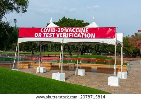 Covid-19 Vaccine or Test Verification sign on banner at the outdoor entrance to public event on stadium