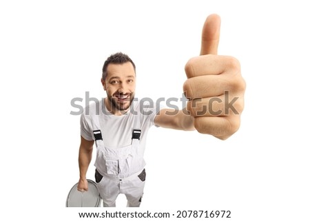 House painter smiling and showing thumbs up in front of camera isolated on white background