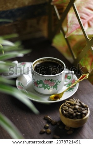 vintage coffee cup, filled with black coffee. foreground view picture