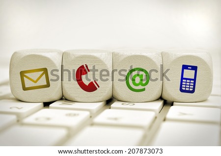 Website and Internet contact us page concept with colored icons on cubes on a keyboard Royalty-Free Stock Photo #207873073