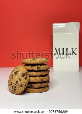 Selective focus on Chocolate chip cookies with red background and milk bottle