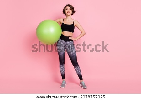 Full body photo of young sportive girl happy positive smile hold fitball activity isolated over pink color background