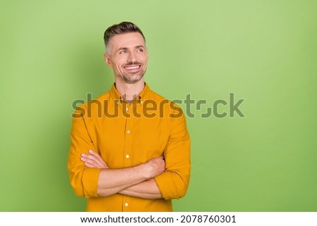 Photo of cool white hairdo mature man crossed arms look promo wear yellow shirt isolated on green color background