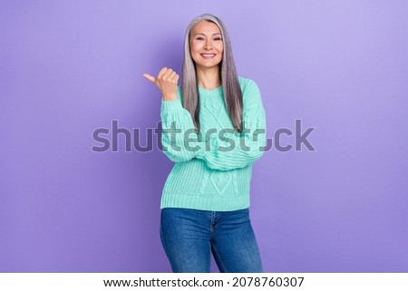 Photo of mature lady indicate finger empty space promotion recommend ads isolated over violet color background