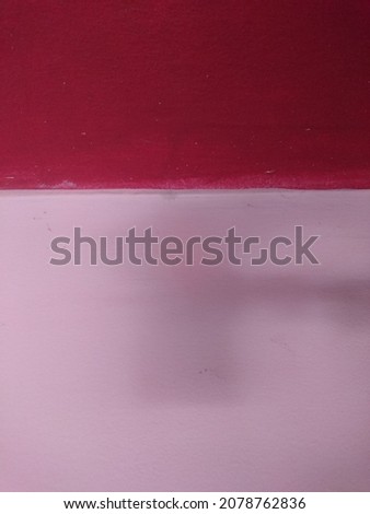 Two tone pink and red colors of concrete cement wall background texture split half of image. Creative design wallpaper in green color.