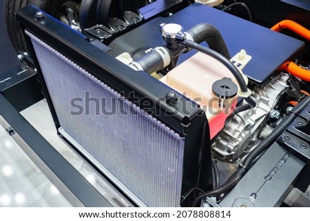 Cooling radiator inside car. Car radiator inside dismantled bonnet. Inside car. Concept - filter replacement. Installing new cooling filter. Engine cooling system repair. Car repair. Royalty-Free Stock Photo #2078808814