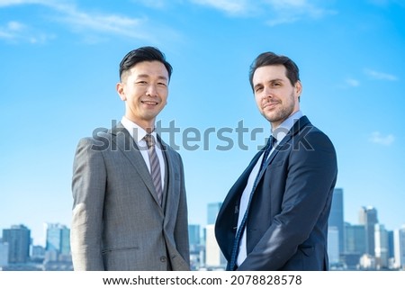 Asian and European businessmen and blue sky