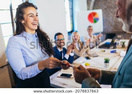 Businesswoman receiving award from businessman in front of business professionals, applauding at business seminar in office building Royalty-Free Stock Photo #2078837863