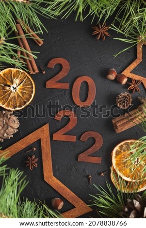 New Year's decoration. Space for text. Wooden stars, cones and pine branches.
