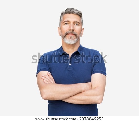 Handsome mature man with arms crossed studio portrait, isolated on gray background Royalty-Free Stock Photo #2078845255