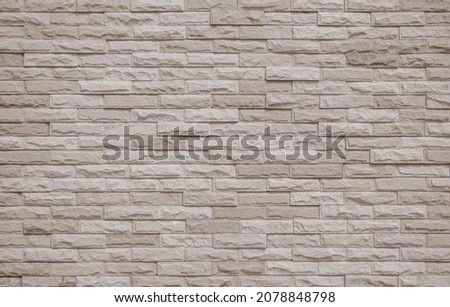 Cream and beige brick wall texture background. Brickwork and stonework flooring interior rock old pattern clean concrete grid uneven bricks office design. Background of old vintage brick wall backdrop