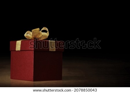 Red gift box on dark background