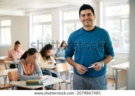 Portrait of happy male professor during a class at high school looking at camera. Royalty-Free Stock Photo #2078867485