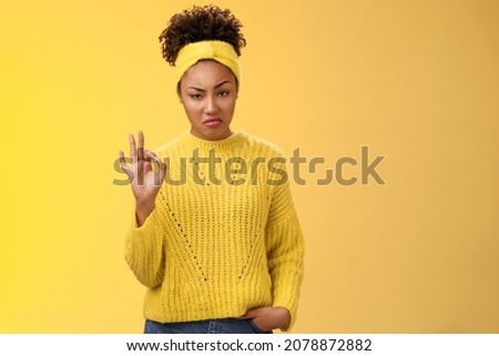 Well not bad. Portrait serious-looking confident arrogant young african-american woman agree effort good show okay ok normal gesture smug approval, standing yellow background impressed Royalty-Free Stock Photo #2078872882