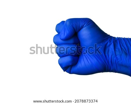 Fist, a hand gesture in a blue medical latex glove on a white background, isolate, copy space. The concept, sign, protection against  virus, flu and coronavirus.