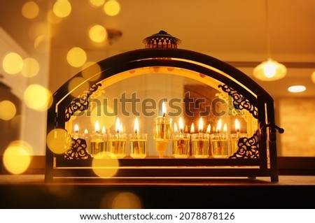 Religion image of jewish holiday Hanukkah background with menorah (traditional candelabra) and oil candles