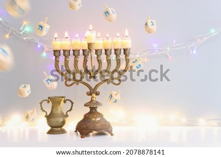 Religion image of jewish holiday Hanukkah background of spinning tops with letters that mean, A 
GREAT MIRACLE HAPPENED HERE, and menorah