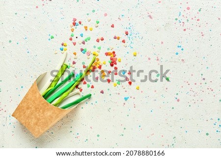Festive composition with balloons and confetti on light background