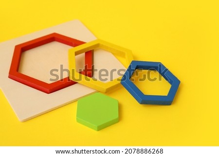 Wooden toy on color background