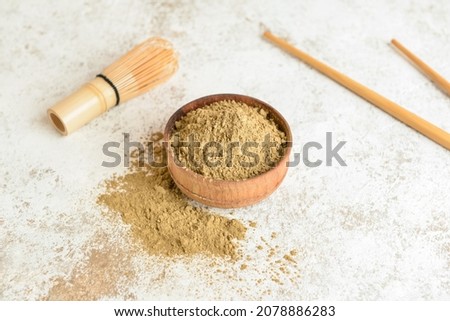 Bowl with hojicha powder on light background
