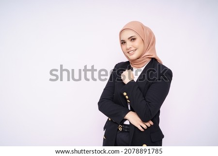 Portrait of hijab girl smiling. Pretty muslim girl. Beautiful asian muslim woman model in formal office attire posing over white background studio. Royalty-Free Stock Photo #2078891785