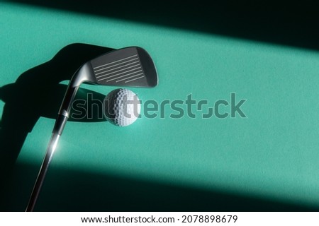 White golf ball and stick with natural lighting on green background. Horizontal sport poster, greeting cards, headers, website