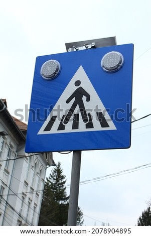 Solar-illuminated pedestrian crossing sign.
Watch out for pedestrians