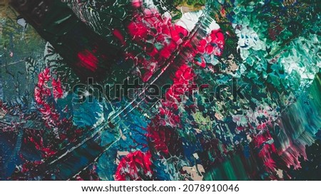 Abstract Textured Background with Bright Pink, Shades of Blue and Green Colors Splattered on a Black Canvas with Acrylic Paint.