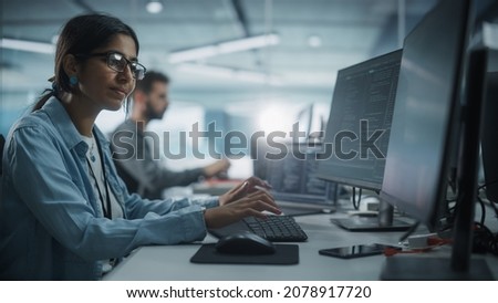 Diverse Office: Indian IT Programmer Working on Desktop Computer. Female Specialist Creating Innovative Software. Engineer Developing App, Program, Video Game. Writing Code in Terminal. Royalty-Free Stock Photo #2078917720