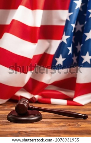Wooden judge gavel and soundboard on american flag background. Justice of law system conceptual.