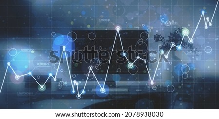 Close up of workplace with computer monitor and abstract glowing business chart on blurry grid background. Digital economy and big data concept. Double exposure
