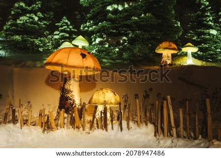 Dark magic forest with big glowing mushrooms. Winter night.