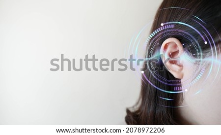 Ear of young woman with sound waves simulation technology. Concept of hearing test, hearing aids, ear disorders and health care. Royalty-Free Stock Photo #2078972206