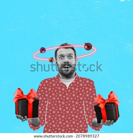 Young excited man with christmas gift boxes isolated on blue background. Contemporary art collage, desing for greeting card, Concept of care, love, rights, winter, holidays, sales, ad and wishes, New