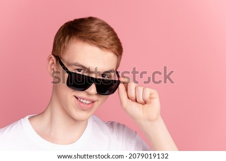 Photo of young cheerful man wear sunglass confident cool trip journey isolated over pink color background