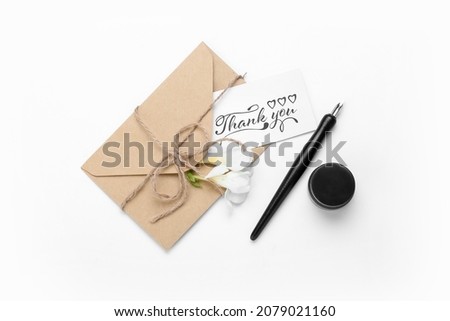 Letter with text THANK YOU, nib pen and ink on white background
