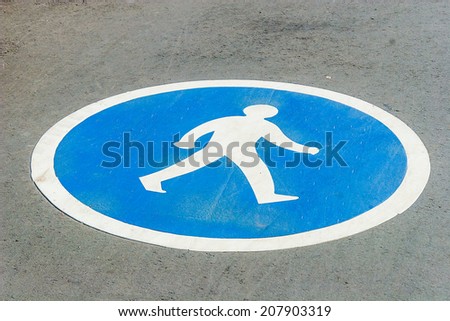 Pedestrian lane blue sign on asphalt road