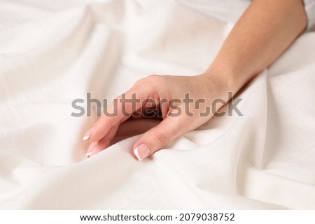 Woman touching smooth silky fabric, closeup view Royalty-Free Stock Photo #2079038752