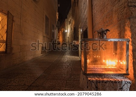 Hanukkah candles are lit, placed at the entrance to a narrow street in the Old City of Jerusalem, Hanukkah