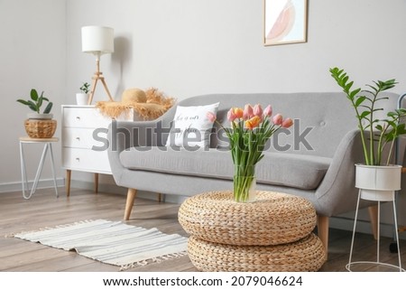 Bouquet of beautiful tulip flowers in interior of living room