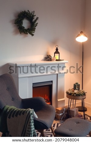 Interior of modern room with fireplace and armchair