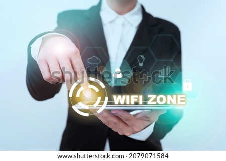 Text sign showing Wifi Zone. Word for provide wireless highspeed Internet and network connections Lady In Suit Pointing On Tablet Showing Futuristic Graphic Interface.